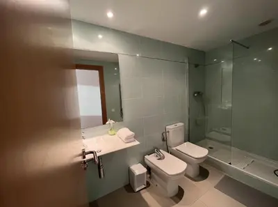 a bathroom with a toilet and a sink and a shower at Beach & Culture Barcelona Port Forum Penthouse Apartment in Sant Adria de Besos