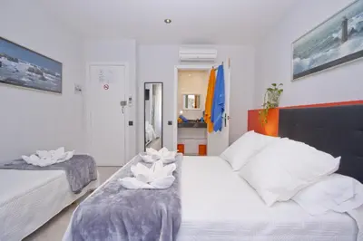 a bedroom with two beds with towels on them at Barcelona City Centre Hostal in Barcelona