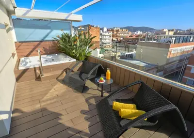 a balcony with chairs and a hot tub on a roof at KAKTUS Hotel Volga in Calella