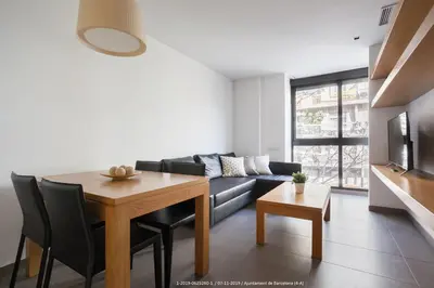 a living room with a table and a couch at Flateli Navas D01 in Barcelona