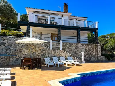 a villa with a swimming pool and a house at Vivalidays Casa Ricardo in Sant Cebrià de Vallalta
