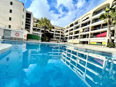 a large swimming pool in front of a building at Apartemento piscina centro calella 3 min playa in Calella