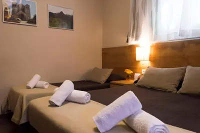 a hotel room with two beds with towels on them at Hostal Alogar in Barcelona