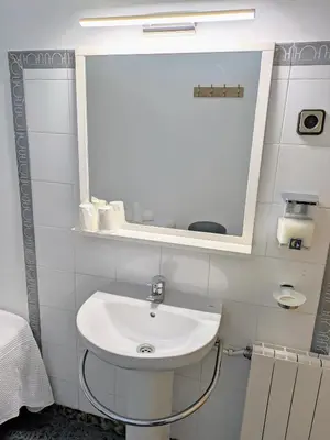 a bathroom with a sink and a mirror at Hostal Alogar in Barcelona