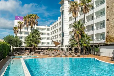 a hotel with a swimming pool in front of a building at FERGUS Club Pineda Splash in Pineda de Mar