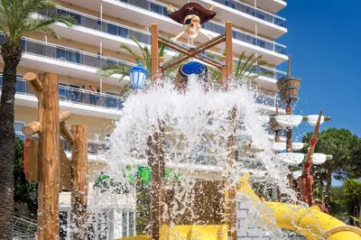a water fountain in front of a building at Hotel Oasis Park Splash in Calella