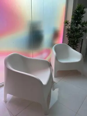 a white chair and a stool in a room at Hotel Oasis Park Splash in Calella