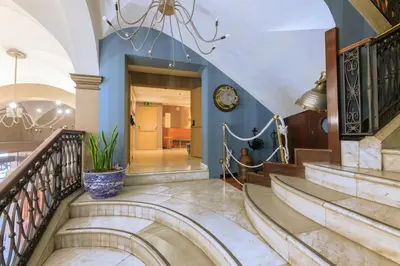 a staircase in a house with a clock on the wall at Hotel del Mar in Barcelona