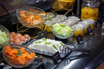 a buffet of food with eggs and fruits and vegetables at Hotel del Mar in Barcelona