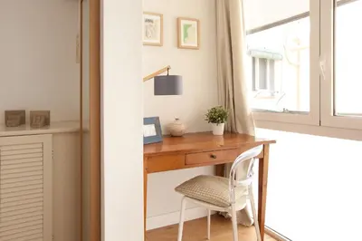 a desk in a room with a window and a chair at Click&Flat Stylish Torrijos in Barcelona