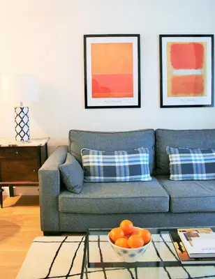 a living room with a couch and a bowl of oranges at Click&Flat Stylish Torrijos in Barcelona