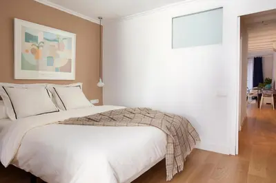 a white bedroom with a large white bed in it at Click&Flat Stylish Torrijos in Barcelona