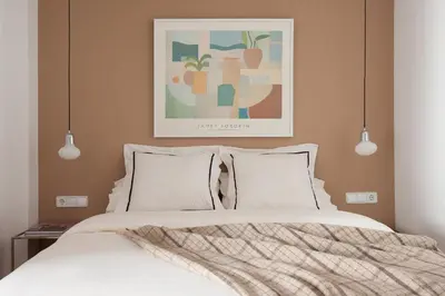 a bedroom with a bed with a picture on the wall at Click&Flat Stylish Torrijos in Barcelona