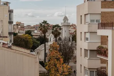 a christmas tree on a city street with buildings at Petit Luxe Volta ÀTIC in Terrassa