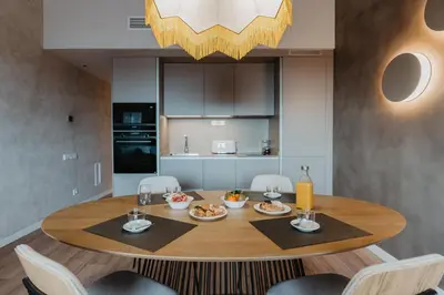 a dining room with a table with food on it at Petit Luxe Volta ÀTIC in Terrassa