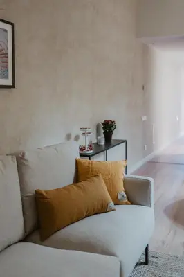 a living room with a white couch with a yellow pillow at Petit Luxe Volta ÀTIC in Terrassa