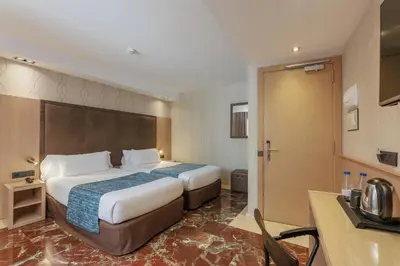 a hotel room with a bed and a bathroom at Hotel Gótico in Barcelona