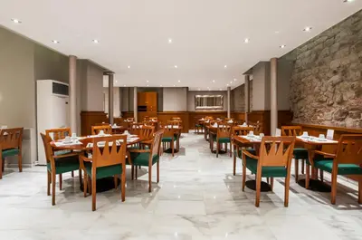 a dining room with wooden tables and chairs at Hotel Gótico in Barcelona
