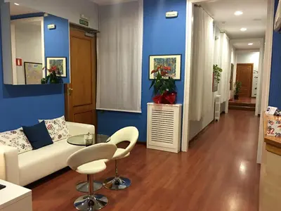a living room with a white couch and a table at Hotel Pelayo in Barcelona
