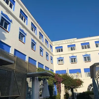 a building with a hotel with an umbrella at Cèsar in Vilanova i la Geltrú
