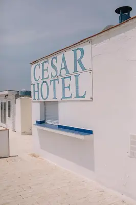 a sign for a casar hotel on the side of a building at Cèsar in Vilanova i la Geltrú