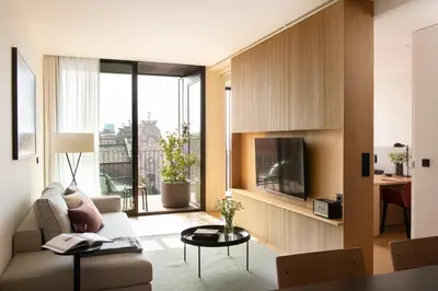a kitchen with black cabinets and a table and chairs at Archie Living in Barcelona