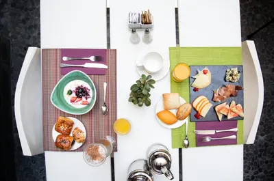 a table with plates of food on it at Pestana Arena Barcelona in Barcelona