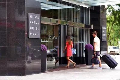 two people walking in front of a hotel at Pestana Arena Barcelona in Barcelona