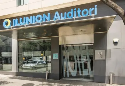 a bedroom with a large white bed in a room at Ilunion Auditori in Barcelona