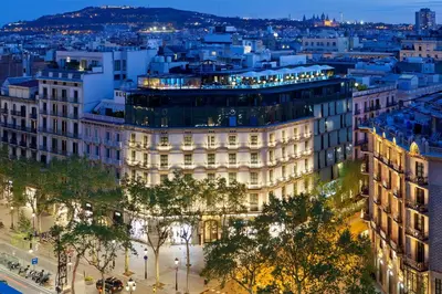 a view of a building in a city at night at Hotel Condes de Barcelona in Barcelona