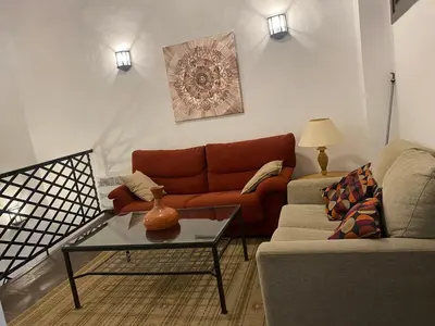 a living room with a couch and a table at Cal Castlà in La Granada