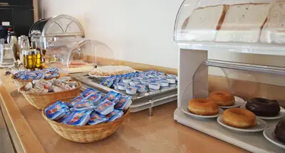 a display case filled with lots of different types of pastries at Travelodge Barcelona Fira in Hospitalet de Llobregat
