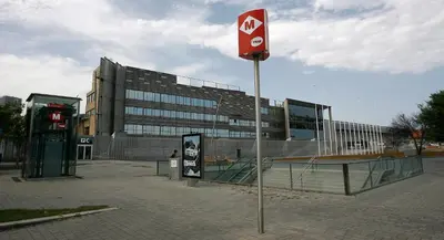 a sign on a pole in front of a building at Travelodge Barcelona Fira in Hospitalet de Llobregat