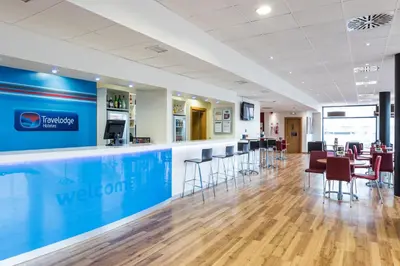a lobby of a hospital with a bar and chairs at Travelodge Barcelona Fira in Hospitalet de Llobregat