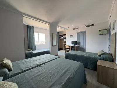 a hotel room with two beds and a desk at Ramblas Hotel in Barcelona