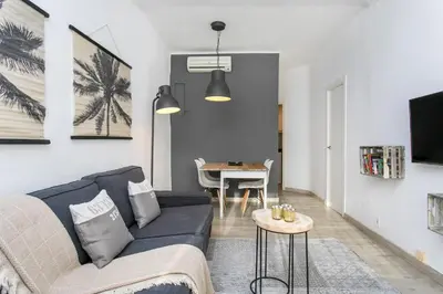 a living room with a couch and a table at Click&Flat Rizal in Barcelona