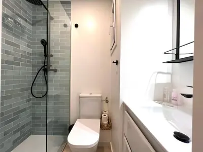 a bathroom with a toilet and a glass shower at Click&Flat Rizal in Barcelona