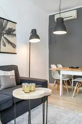 a living room with a couch and a table at Click&Flat Rizal in Barcelona