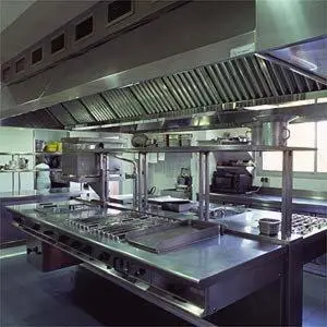 a large commercial kitchen with a large stainless steel counter at Hotel Golf Can Rafel in Corbera de Llobregat