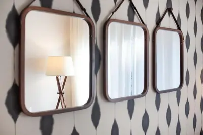 a mirror hanging on a wall with a lamp at Design and comfort in the trendy neighborhood in Barcelona