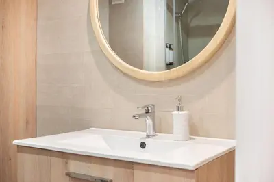 a bathroom with a sink and a mirror at Design and comfort in the trendy neighborhood in Barcelona