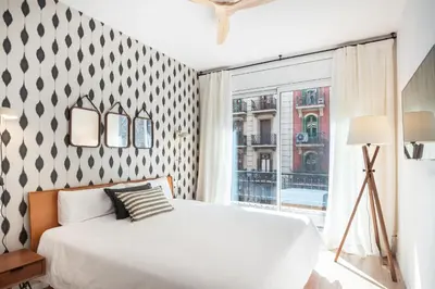 a bedroom with a bed and a large window at Design and comfort in the trendy neighborhood in Barcelona