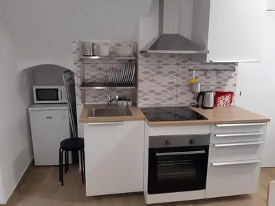a small kitchen with a sink and a stove at Lucky House in Badalona