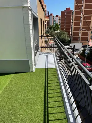 a balcony with green grass on the side of a building at Lucky House in Badalona