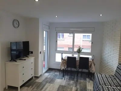 a living room with a table with chairs and a television at Lucky House in Badalona