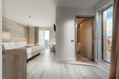 a bedroom with a bed and a large window at Hotel Oasis in Barcelona