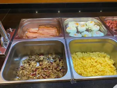 a buffet with trays of different types of food at Hotel Oasis in Barcelona