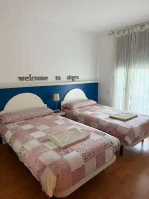 two beds sitting next to each other in a bedroom at La Llum de Sitges in Sitges