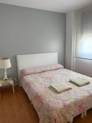 a bedroom with a bed with two pillows on it at La Llum de Sitges in Sitges