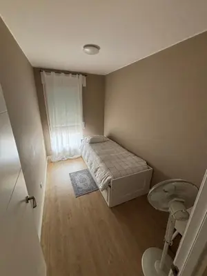 a small bedroom with a bed and a window at Cardedeu City and Circuit apartment in Cardedeu